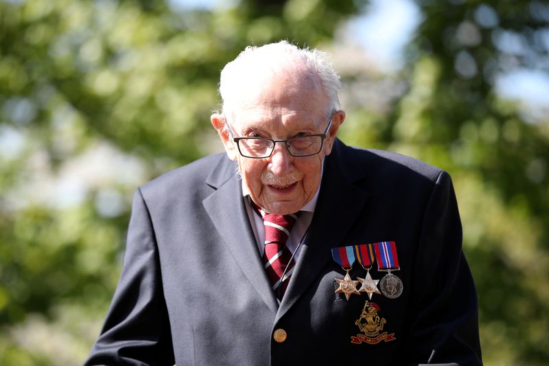 &copy; Reuters. FILE PHOTO: Retired British Army Captain Tom Moore, 99, raises money for health workers by attempting to walk the length of his garden one hundred times before his 100th birthday this month as the spread of coronavirus disease (COVID-19) continues, Marsto