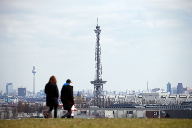 &copy; Reuters. FILE PHOTO: People walk on a field in front of the skyline, during the spread of coronavirus disease (COVID-19) in Berlin, Germany, April 1, 2020. REUTERS/Michele Tantussi