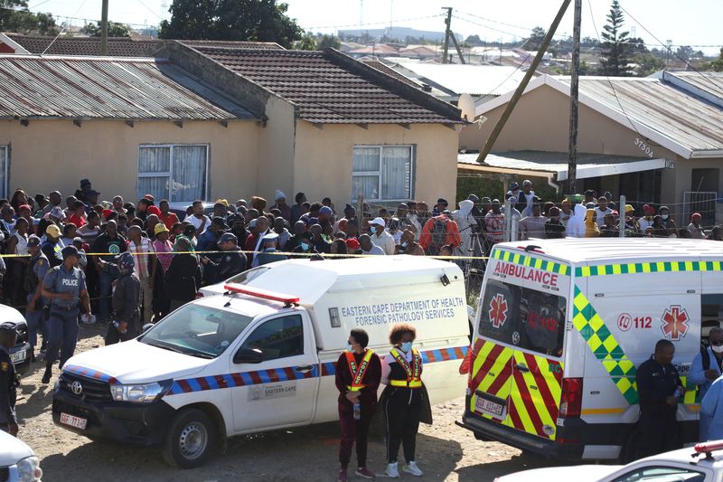 &copy; Reuters. FILE PHOTO: Crowd gathers as forensic personnel investigate after the deaths of patrons found inside the Enyobeni Tavern, in Scenery Park, outside East London in the Eastern Cape province, South Africa, June 26, 2022. REUTERS/Stringer/File Photo