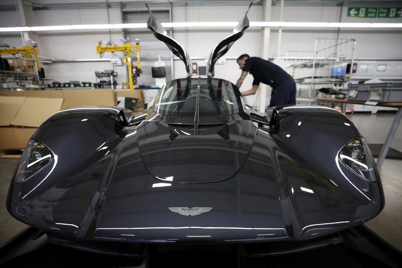 &copy; Reuters. FILE PHOTO: An employee works on the interior of an Aston Martin Valkyrie car at the company’s factory in Gaydon, Britain, March 16, 2022. REUTERS/Phil Noble