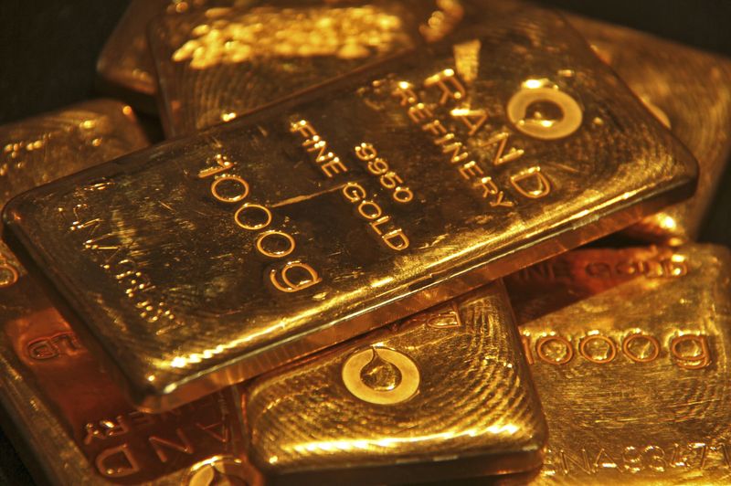 Gold inches down as U.S. bond yields bounce back