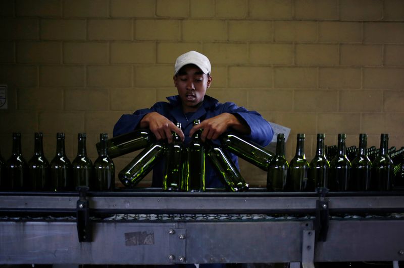 &copy; Reuters. FILE PHOTO: A worker loads wine bottles onto a conveyer belt at the Rostberg bottling plant near Cape Town, November 29, 2012. REUTERS/Mike Hutchings