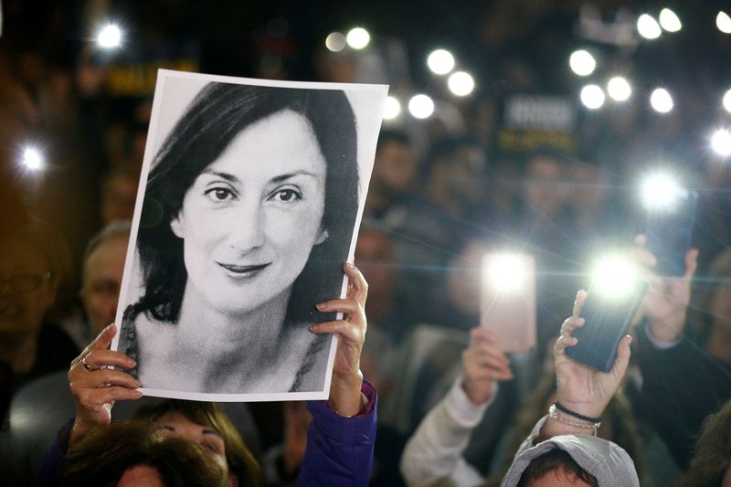 &copy; Reuters. FILE PHOTO: People gather at the Great Siege Square calling for the resignation of Joseph Muscat following the arrest of one of the country's most prominent businessmen as part of the investigation into the murder of journalist Daphne Caruana Galizia, in 