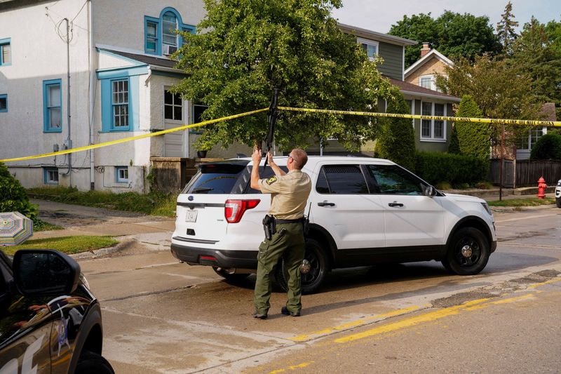 &copy; Reuters. A police officer uses a rifle to lift caution tape outside the home of the mother of the man detained after a mass shooting at a Fourth of July parade route in the Chicago suburb of Highland Park, Illinois, U.S. July 4, 2022.  REUTERS/Cheney Orr