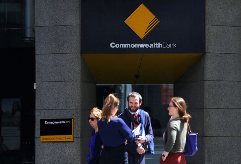 &copy; Reuters. FILE PHOTO: Pedestrians stand outside a branch of the Commonwealth Bank of Australia (CBA), Australia's biggest bank by market value, in central Sydney, Australia, November 8, 2017. REUTERS/Steven Saphore