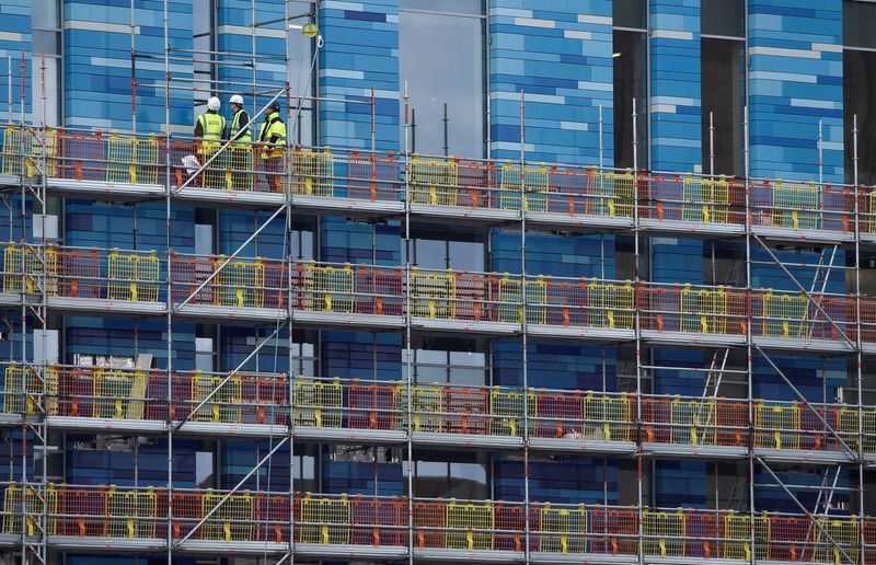 &copy; Reuters. FILE PHOTO: Workers stand on scaffolding at a residential building in London, Britain, March 7, 2016. REUTERS/Toby Melville