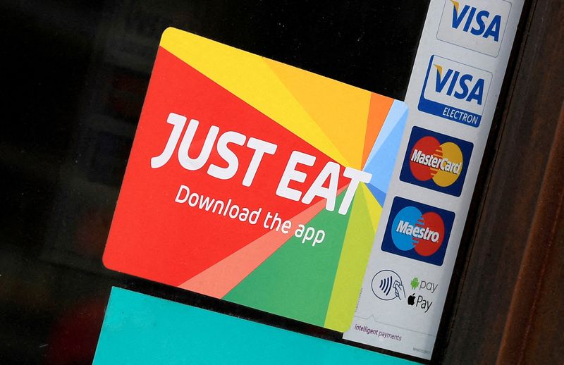 © Reuters. FILE PHOTO: Signage for Just Eat is seen on the window of a restaurant in London, Britain, August 5, 2019. REUTERS/Toby Melville