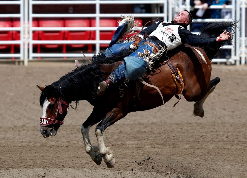 © Reuters. FILE PHOTO: Richmond Champion of Stevensville, Montana rides the horse Yipee Kibitz in the bareback event during the rodeo at the Calgary Stampede in Calgary, Alberta, Canada July 9, 2021.  REUTERS/Todd Korol/File Photo