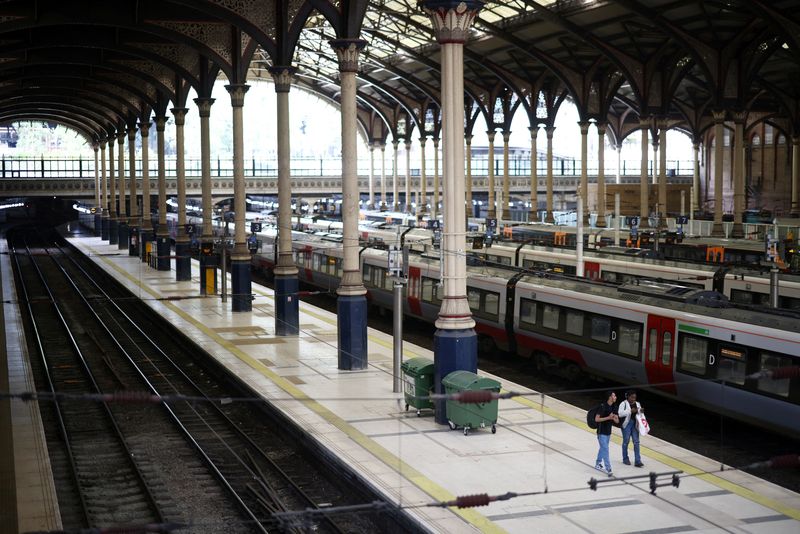 &copy; Reuters. FILE PHOTO: People walk along a platform at Liverpool Street station, during heavily reduced rail services on the third day of national rail strikes, in London, Britain, June 23, 2022. REUTERS/Henry Nicholls
