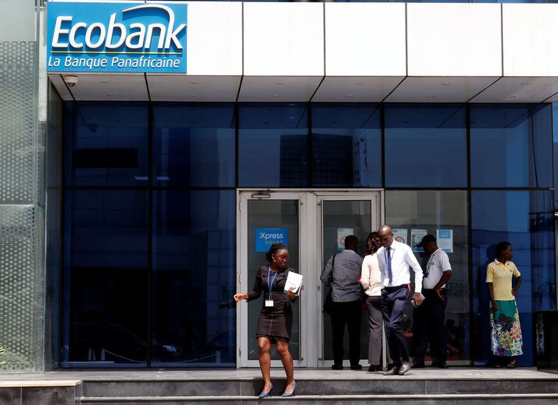 &copy; Reuters. FILE PHOTO: People walk at the entrance of Ecobank building in Abidjan, Ivory Coast June 4, 2018. REUTERS/Luc Gnago