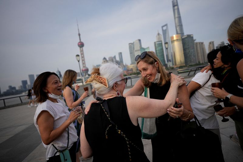 &copy; Reuters. Heather Kaye, 48, greets her friends during a farewell gathering, before leaving China for the U.S., at the Bund, in Shanghai, China June 9, 2022. REUTERS/Aly Song     