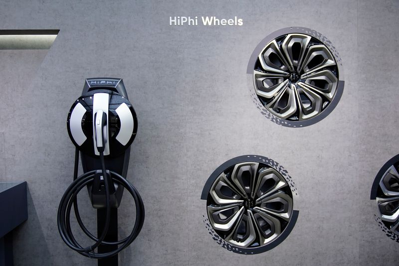 &copy; Reuters. FILE PHOTO: An electric vehicle (EV) charging point and wheels are seen displayed at the HiPhi booth during a media day for the Auto Shanghai show in Shanghai, China April 20, 2021. REUTERS/Aly Song