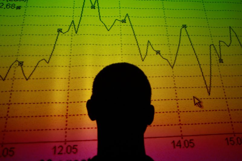 &copy; Reuters. FILE PHOTO: Photo for illustration. A man is silhouetted in an electronic board showing the FTSE MIB Index for the Italian equity market in this photo illustration taken in Rome August  9, 2011.  REUTERS/Tony Gentile./File Photo
