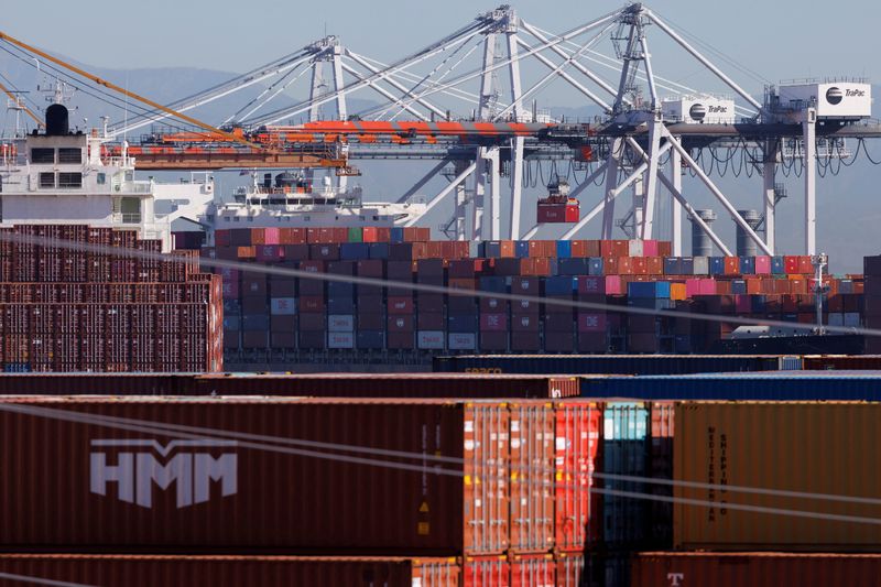 &copy; Reuters. FILE PHOTO: Stacked containers are shown as ships unload their cargo at the Port of Los Angeles in Los Angeles, California, U.S. November 22, 2021. REUTERS/Mike Blake