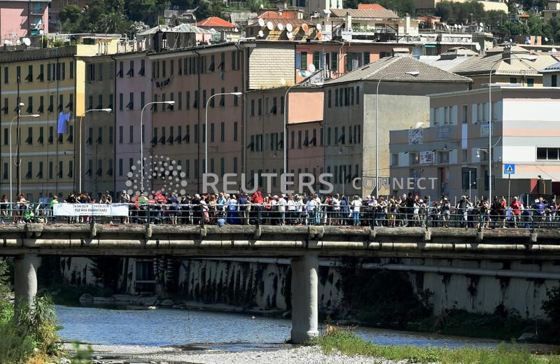 &copy; Reuters. Folla sul Ponte delle Retelle osserva le cerimonie che segnano il primo anniversario del crollo del ponte Morandi che ha ucciso 43 persone. Genova 14 agosto 2019. REUTERS/Massimo Pinca