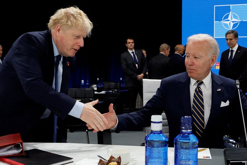 © Reuters. FILE PHOTO: U.S. President Joe Biden and British Prime Minister Boris Johnson shake hands during the Meeting of the North Atlantic Council Session with fellow heads of state at the NATO summit at the IFEMA arena in Madrid, Spain, June 30, 2022. REUTERS/Jonathan Ernst/Pool/File Photo