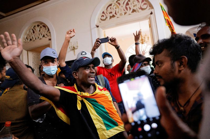 &copy; Reuters. Manifestantes celebran después de entrar en la Casa del Presidente durante una protesta, tras la huida del presidente Gotabaya Rajapaksa, en medio de la crisis económica del país, en Colombo, Sri Lanka. 9 de julio de 2022. REUTERS/Dinuka Liyanawatte 