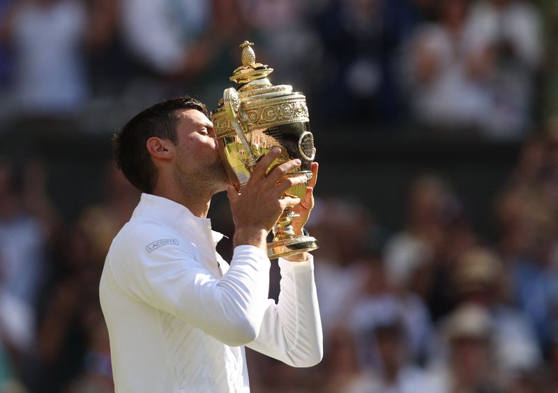 Novak Djokovic lifting a seventh Wimbledon trophy