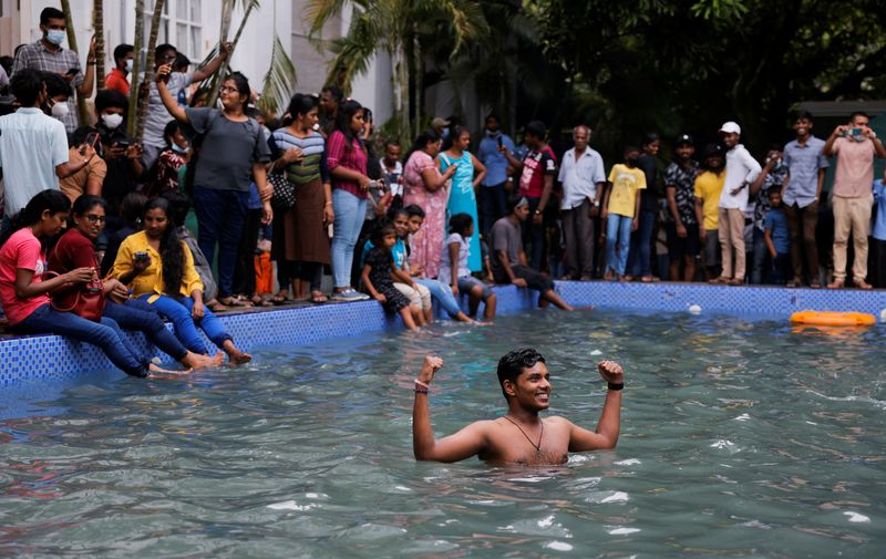 © Reuters. A man stands in the swimming pool as people visit the President's house on the day after demonstrators entered the building, after President Gotabaya Rajapaksa fled, amid the country's economic crisis, in Colombo, Sri Lanka July 10, 2022. REUTERS/Dinuka Liyanawatte