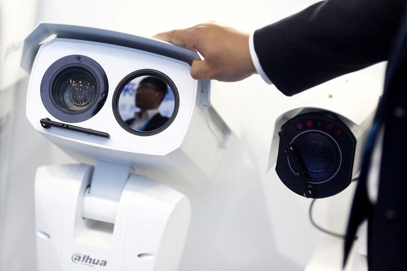 &copy; Reuters. FILE PHOTO: A man adjusts a CCTV camera at the stall of the video surveillance product maker Dahua Technology at the Security China 2018 exhibition on public safety and security in Beijing, China October 23, 2018.  REUTERS/Thomas Peter