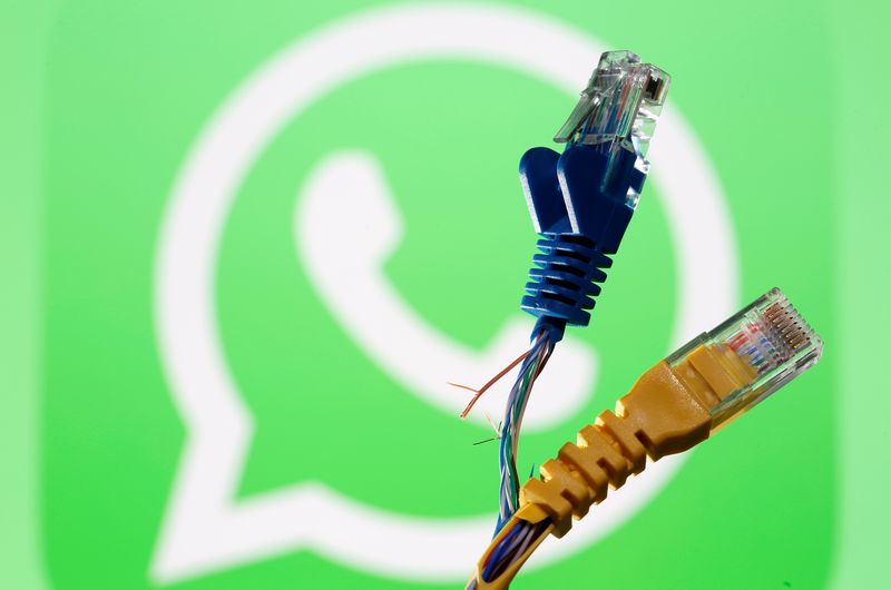&copy; Reuters. Broken Ethernet cables are seen in front of a displayed WhatsApp logo in this illustration taken October 5, 2021. REUTERS/Dado Ruvic/Illustration