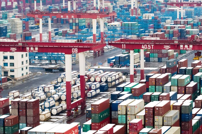 &copy; Reuters. FILE PHOTO: Containers and trucks are seen following a snowfall at the port of Qingdao, Shandong province, China February 14, 2019. REUTERS/Stringer/File Photo