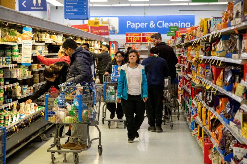 &copy; Reuters. FILE PHOTO: People shop at a Walmart Supercentre amid coronavirus fears spreading in Toronto, Ontario, Canada March 13, 2020. REUTERS/Carlos Osorio