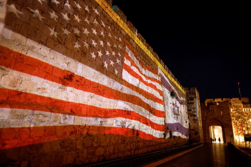 &copy; Reuters. U.S. and Israeli national flags are projected on a part of the walls surrounding Jerusalem's Old City July 13, 2022. REUTERS/Ammar Awad