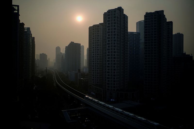 &copy; Reuters. FILE PHOTO: Buildings are seen at sunset, almost a year after the global outbreak of the coronavirus disease (COVID-19) in Wuhan, Hubei province, China December 12, 2020. REUTERS/Aly Song