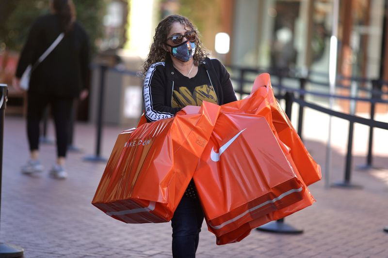 &copy; Reuters. FILE PHOTO: A woman carries Nike shopping bags at the Citadel Outlet mall, as the global outbreak of the coronavirus disease (COVID-19) continues, in Commerce, California, U.S., December 3, 2020. REUTERS/Lucy Nicholson