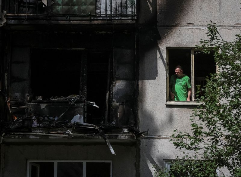 &copy; Reuters. A local resident looks out through a broken window in his flat in a residential building damaged by a Russian military strike, amid Russia's invasion on Ukraine, in Kramatorsk, in Donetsk region, Ukraine July 19, 2022. REUTERS/Gleb Garanich
