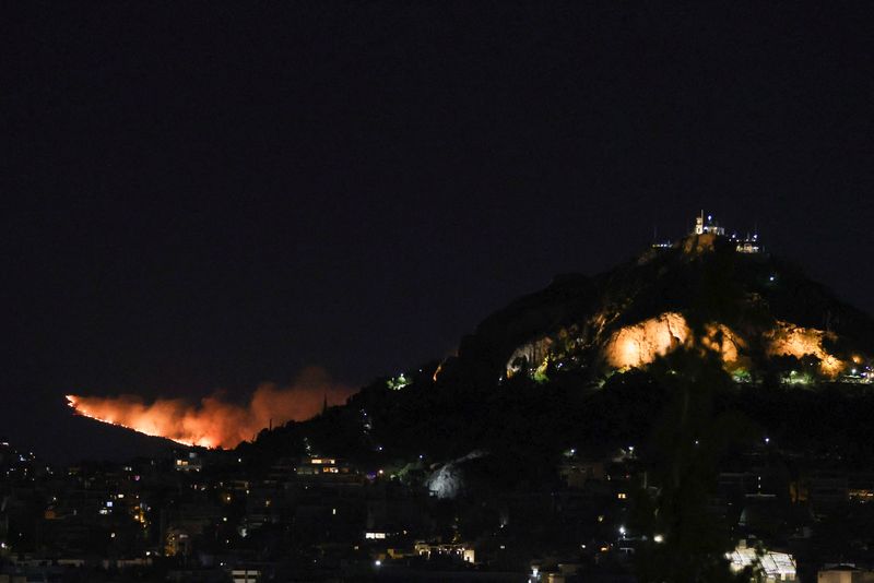 &copy; Reuters. حرائق غابات مستعرة في جبل بينتيلي باليونان يوم الثلاثاء. تصوير: ستيليوس ميسيناس - رويترز
