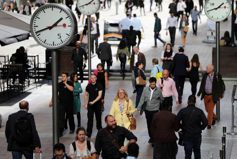 &copy; Reuters. FILE PHOTO: People walk through the financial district of Canary Wharf, London, Britain 28 September 2017. REUTERS/Afolabi Sotunde