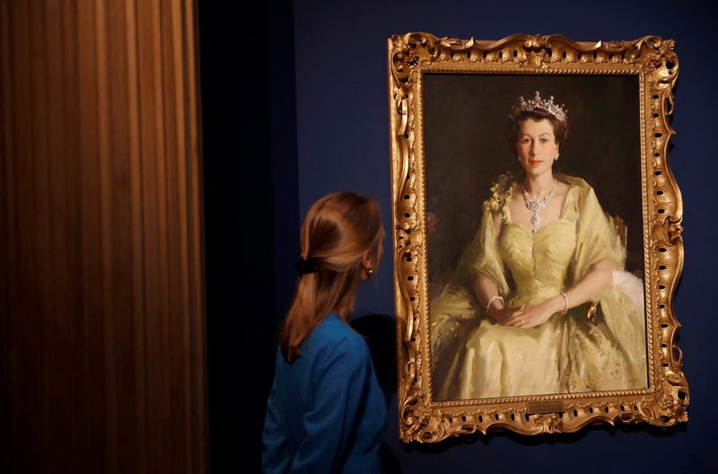&copy; Reuters. A staff member of the Royal Collection Trust poses for a photograph next to a painting known as the Wattle Portrait and is part of, Platinum Jubilee: The Queen’s Coronation exhibition at Windsor Castle, Windsor, Britain, July 6, 2022. REUTERS/Peter Nich