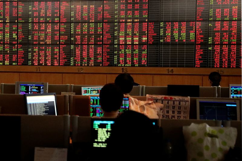 &copy; Reuters. Traders are seen in front of a screen with trading figures in red at Thailand Stock Exchange building in Bangkok, Thailand March 13, 2020. REUTERS/Juarawee Kittisilpa