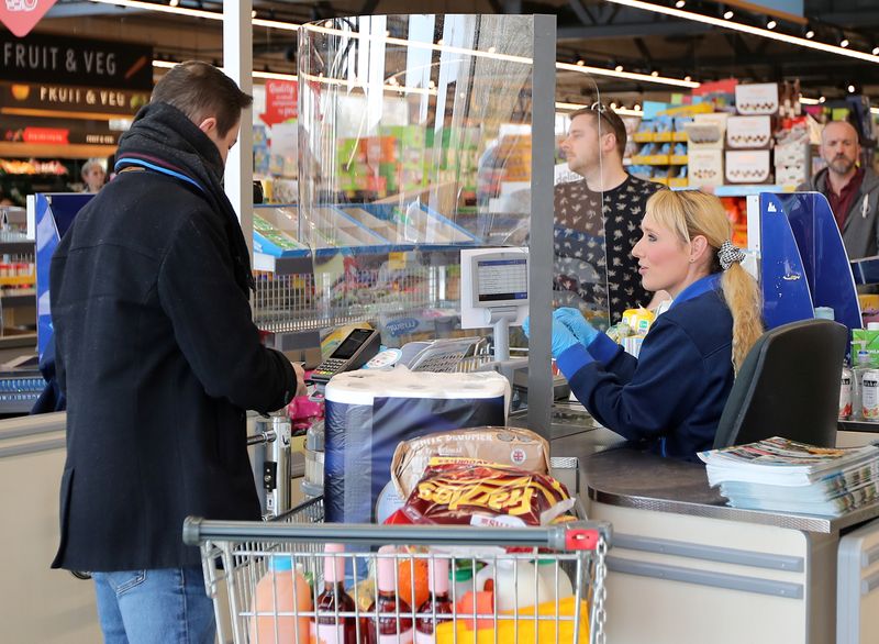 &copy; Reuters. Plastic screens are pictured around tills in an Aldi store as people shop in Northwich as the spread of the coronavirus disease (COVID-19) continues, in Northwich, Britain, March 27, 2020. REUTERS/Molly Darlington