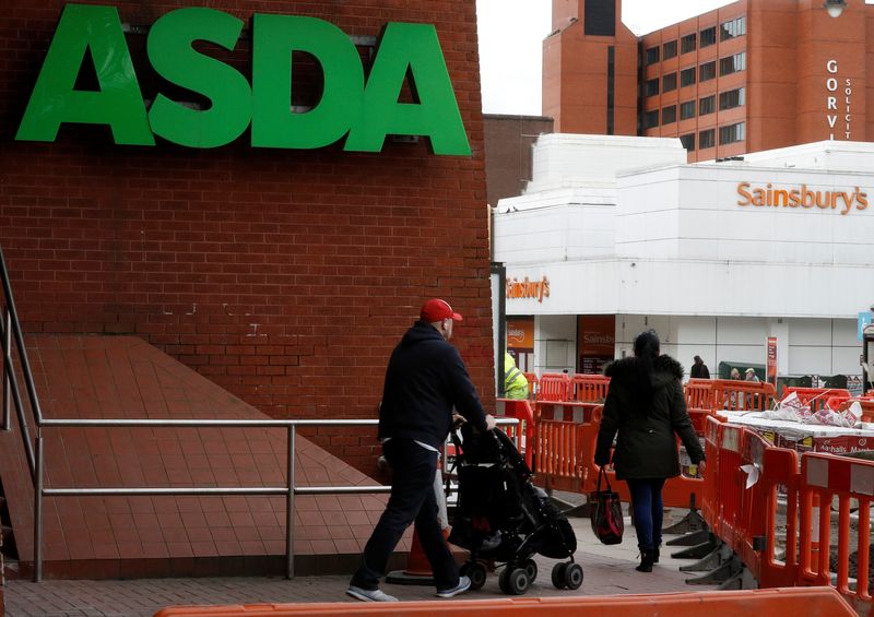 &copy; Reuters. People walk past branches of ASDA and Sainsbury's in Stockport, Britain April 30, 2018. REUTERS/Phil Noble