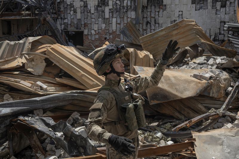 &copy; Reuters. Teren, a member of the Carpathian Sich battalion, walks through a destroyed building, at the frontline in Kharkiv region, Ukraine, July 1, 2022. At the sharp end of efforts to stop the Russian army's progress in eastern Ukraine are the Carpathian Sich bat