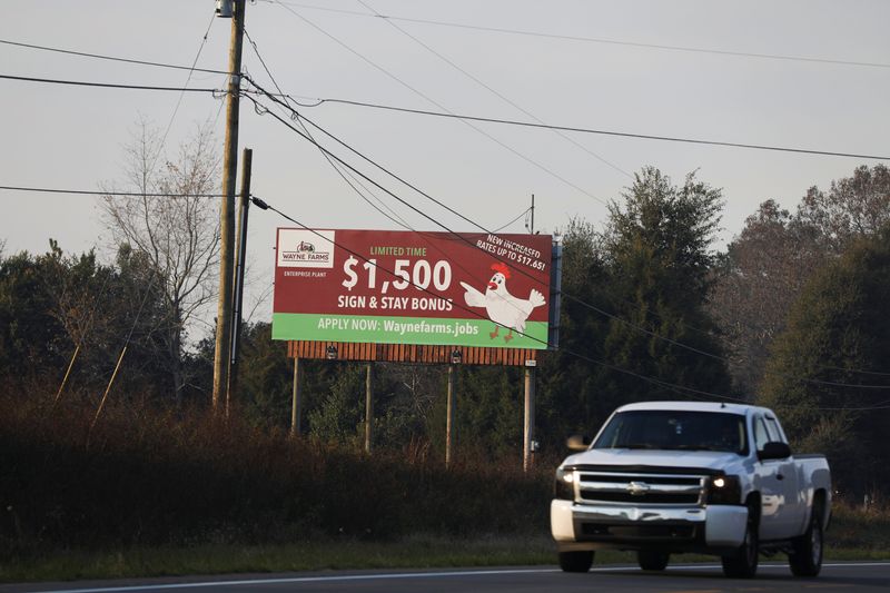 &copy; Reuters. FILE PHOTO: A billboard advertising signing bonuses and increased wages for the Wayne Farms poultry processing plant in Enterprise, Alabama, is displayed along Neil Metcalf Road, in Enterprise, Alabama, U.S., November 30, 2021. REUTERS/Alyssa Pointer 