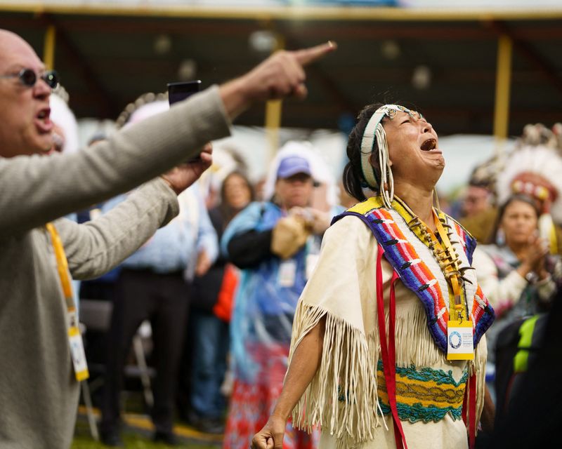 © Reuters. A woman sings Canada's national anthem in the Cree language during a visit by Pope Francis, who apologized to Canada's native people on their land for the Church's role in schools where indigenous children were abused, in Maskwacis, Alberta, Canada July 25, 2022.  Adam Scotti/Prime Minister's Office/Handout via REUTERS 