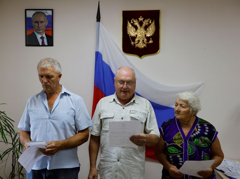 Beneath a portrait of Putin, some Ukrainians embrace Russian passports