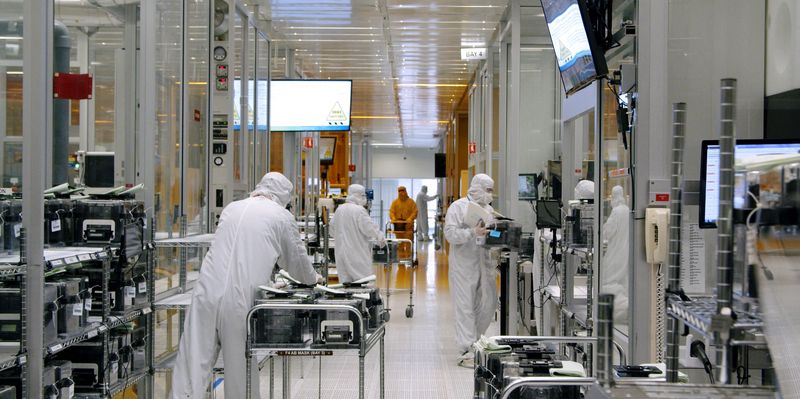 &copy; Reuters. FILE PHOTO: Workers work inside the clean room of U.S. semiconductor manufacturer SkyWater Technology Inc where computer chips are made, in Bloomington, Minnesota, U.S., April, 2022 in this handout picture acquired by Reuters on July 19, 2022. SkyWater Te