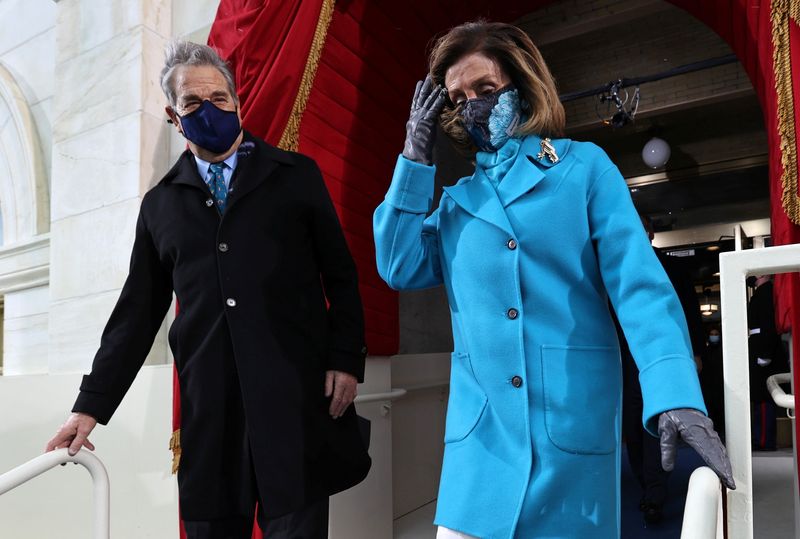 © Reuters. FILE PHOTO: Speaker of the House Nancy Pelosi arrives with her husband Paul Pelosi during the inauguration of Joe Biden as the 46th President of the United States on the West Front of the U.S. Capitol in Washington, U.S., January 20, 2021. REUTERS/Jonathan Ernst/Pool