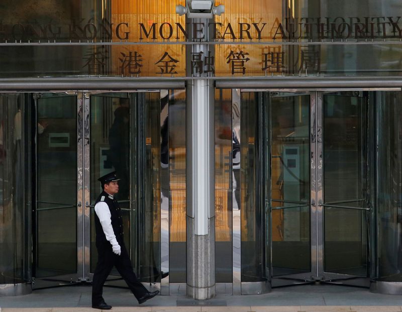 &copy; Reuters. FILE PHOTO: An attendant walks outside the entrance to Hong Kong Monetary Authority in Hong Kong, China November 10, 2015. REUTERS/Bobby Yip