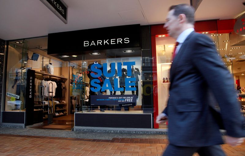 &copy; Reuters. FILE PHOTO: A businessman walks past a shop having a sale on Lambton Quay in Wellington September 23, 2009. REUTERS/Anthony Phelps