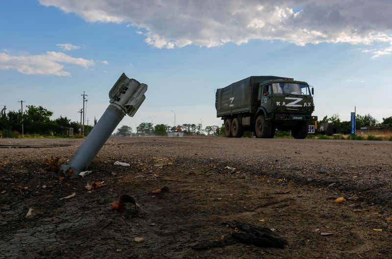 © Reuters. A Russian military truck drives past an unexploded munition during Ukraine-Russia conflict in the Russia-controlled village of Chornobaivka, Ukraine July 26, 2022. REUTERS/Alexander Ermochenko