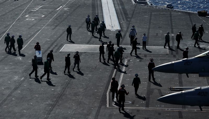 &copy; Reuters. FILE PHOTO: Crew members work on the deck of the USS Ronald Reagan in the South China Sea September 30, 2017. REUTERS/Bobby Yip