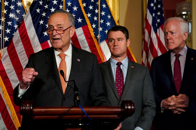 &copy; Reuters. U.S. Senate Majority Leader Chuck Schumer (D-NY) speaks as U.S. Senators Todd Young (R-IN) and John Cornyn (R-TX) listen during a news conference after the U.S. Senate passed legislation to subsidize the domestic semiconductor industry, at the U.S. Capito