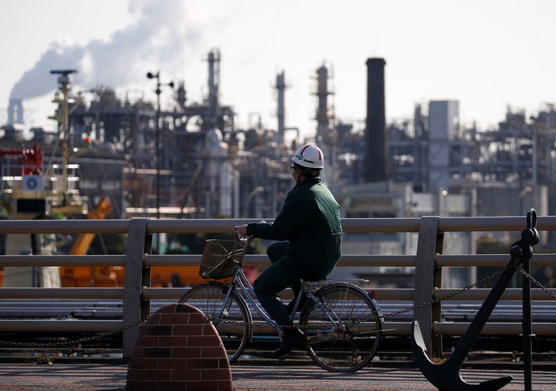 &copy; Reuters. FILE PHOTO: A worker cycles near a factory at the Keihin industrial zone in Kawasaki, Japan February 28, 2017. REUTERS/Issei Kato