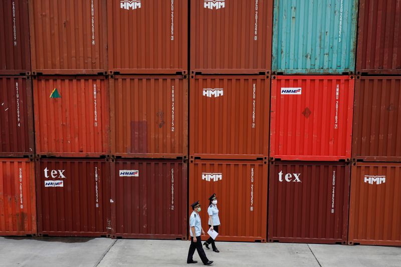 &copy; Reuters. Vietnamese customs officers wearing protective masks patrol at a containers port, amid the spread of the coronavirus disease (COVID-19), in Quang Ninh province, Vietnam August 13, 2020. REUTERS/Kham